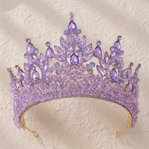 Detailed macro view of luxury bridal crown featuring purple crystals on a golden frame