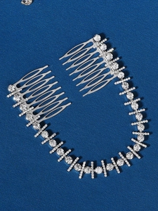 Detailed view of silver bridal hair comb with cubic zirconia chain on blue background