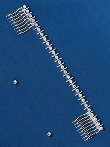 Detail of silver bridal hair comb with luxury rhinestones and soft chain link styling