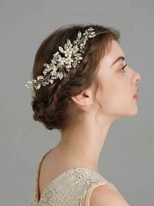 Close-up of handmade bridal hair comb with pearls and crystals on a female model
