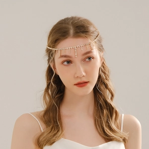 Detail view of boho gold bridal forehead chain with sparkling rhinestone tassels