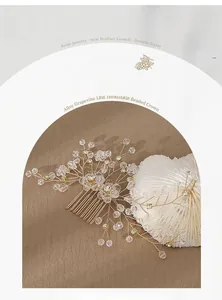 Detailed close-up of handmade bridal hair comb with gold wires, crystals and pearls