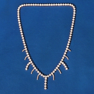 Detailed view of bridal rhinestone head chain featuring crystal tassels on gold setting