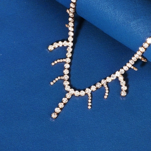 Close-up of golden branch-shaped bridal headpiece with sparkling rhinestones