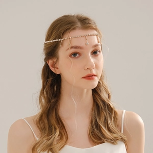 Detailed close-up of bohemian gold bridal head chain with sparkling crystal pendants