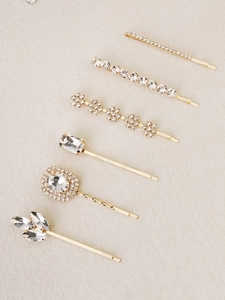 Detail view of 6-piece gold hair clip set with various rhinestone shapes and crystal designs