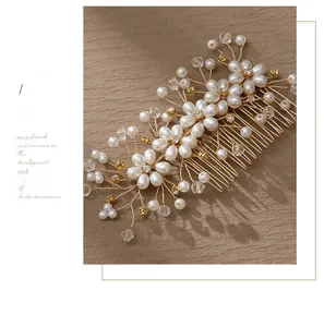Close-up of bridal hair comb with handmade pearl flowers and crystal beads detail