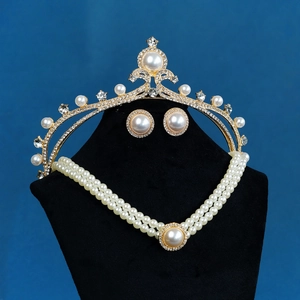 Dettaglio del set di gioielli da sposa con perle e strass su supporto di velluto nero
