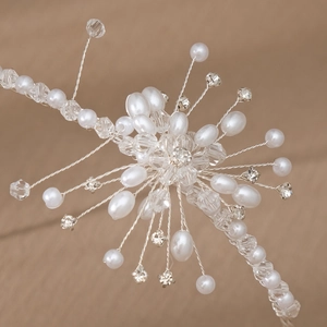 Detailed macro view of handmade pearl floral headband with crystals and silver wires