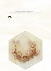 Detailed close-up of rose gold floral headband with delicate petals and white pearls