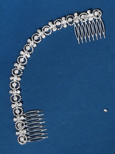 Close-up of a silver bridal hair comb featuring elegant rhinestones and floral designs
