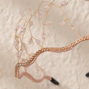 Detail of handmade gold wire bridal headband with pink ribbon base and crystal beads