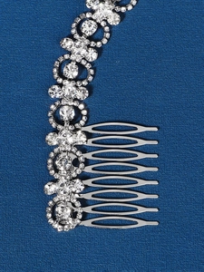 Close-up of luxury bridal hair comb featuring intricate rhinestone cross and circle patterns