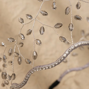 Detailed view of silver wire branches and grey crystal beads on a handmade headband