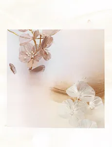 Macro detail of handmade wire-wrapped flower petals with pearls on a bridal headband