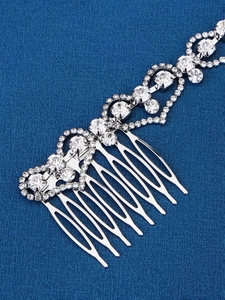 Detail shot of heart-shaped rhinestone hair comb with sparkling silver decorative chain