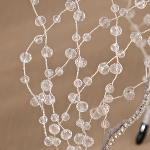 Close-up of handmade bridal headband with silver mesh wire and faceted crystal beads