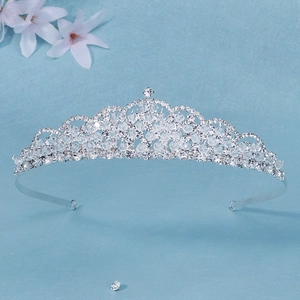 Dettaglio ravvicinato di una tiara da sposa argentata con strass di cristallo su carta blu