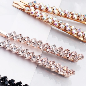 Detailed macro view of five-piece rhinestone hair clip set with rose gold metal finish