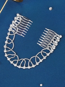 Close-up of sparkling rhinestone hair comb with silver chain for bridal styling