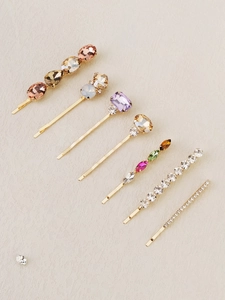 Detailed view of 7-piece hair clip set featuring colorful rhinestones and gold metal base
