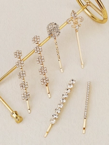 Close-up of golden hair clips with sparkling rhinestones and elegant vintage designs