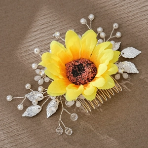 Handmade yellow sunflower bridal hair comb with pearls and crystals on brown fabric