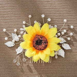 Detail of sunflower hair comb with yellow fabric petals, pearls, and silver leaves