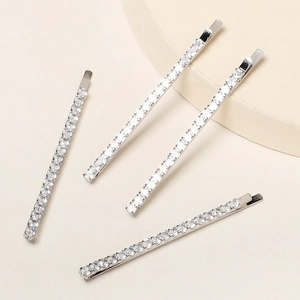 Detailed view of four silver-plated hairpins with rows of sparkling zircon stones