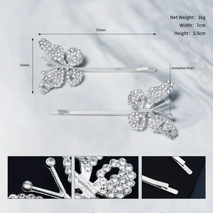 Detailed view of silver butterfly hair clips with sparkling rhinestones and imitation pearls