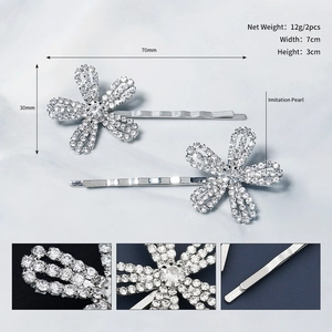 Detailed view of silver flower hair clip with sparkling rhinestones and pearls showing size