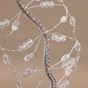Macro detail of handmade bridal headband featuring silver wire mesh and crystal beads