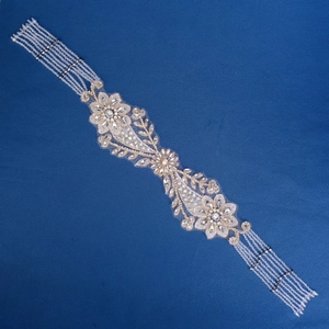 Exquisite bridal headband with hand-sewn rhinestones and floral crystal beads on blue background