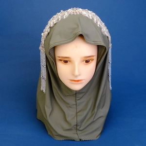 Detailed view of dark green hijab with silver rhinestone crown and beaded fringe trim