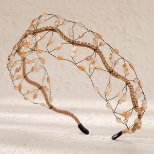 Detailed macro view of handmade bridal headband with champagne crystals and woven mesh wire