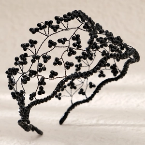 Macro view of handmade black beaded bridal headband with intricate wire branch details