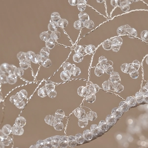 Close-up of handmade bridal headband with silver wire mesh and sparkling crystals