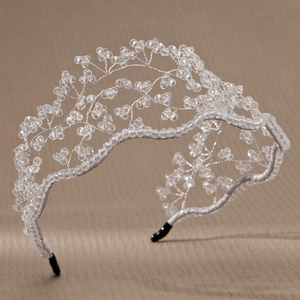 Detailed view of silver wire branch bridal headband with crystal beads on beige leather