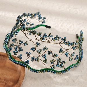 Macro detail of handmade bridal headband with blue crystals and woven wire crown