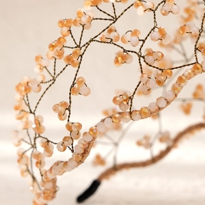 Detailed macro view of handmade bridal headband with champagne crystal beads and woven wire