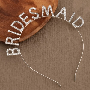 Macro view of crystal rhinestone BRIDESMAID headband on a premium leather texture