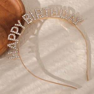 Macro detail of gold HAPPY BIRTHDAY headband with sparkling crystal rhinestones