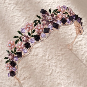 Detailed macro view of floral crown with purple crystals and pink pearls on gold metal