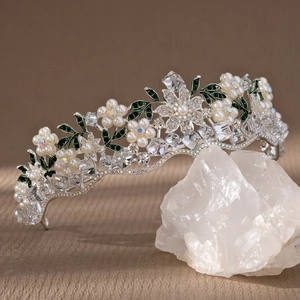 Vintage bridal crown with purple crystal, white pearls, and green enamel leaf accents