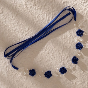 Detail of handmade deep blue fabric roses with pearls on a silver wire bridal headband