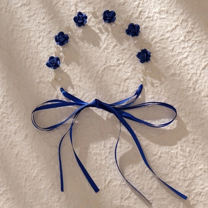 Detail of dark blue floral bridal headband with pearls, crystals and satin ribbons