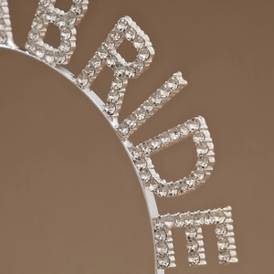 Close-up of sparkling rhinestones on the BRIDE letter crown tiara with silver metal