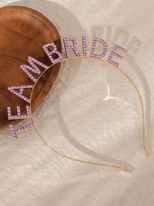 Detail of Team Bride crown headband with purple rhinestones on a gold alloy frame