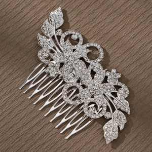 Detailed view of bridal silver flower hair comb with sparkling crystals on textured background