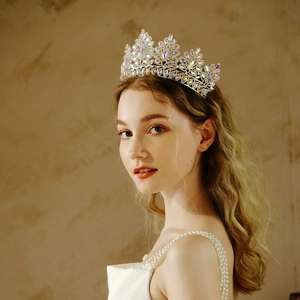 Detail of silver tiara with colorful AB rhinestones worn by a bride on a warm background